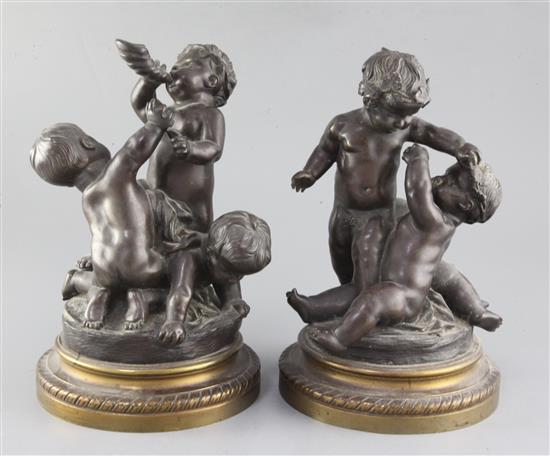 A pair of 19th century bronze groups of wrestling putti, height 10.75in.